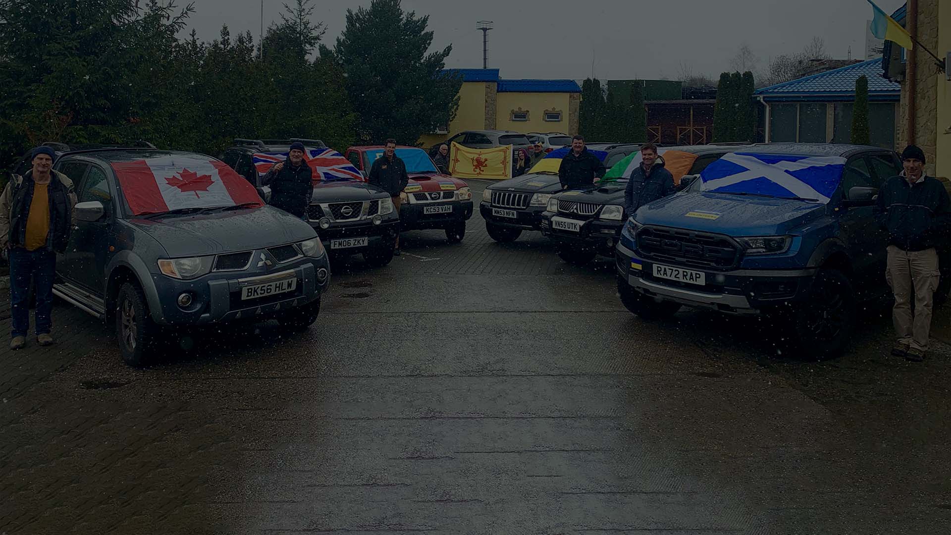 A picture on a showy day with volunteers from various European countries with the donated cars.